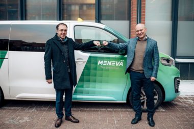 Minister Robert Troy in front of a Meneva taxi