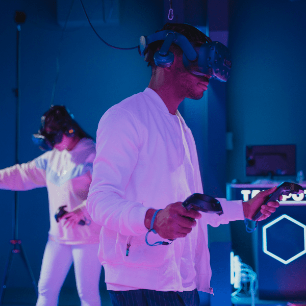 A man and woman wearing headsets for immersive entertainment purposes